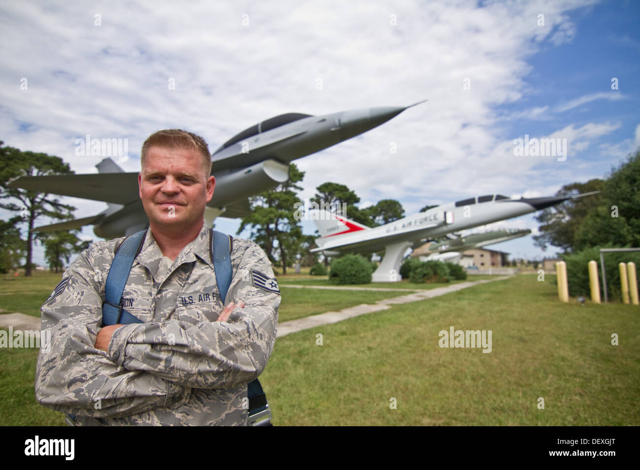 U.S. Air Force Staff Sgt. Bryan Lemmon from the New Jersey Air National Guard's 177th Fighter Wing stands in front of the F-106B Delta Dart and the F-16B Fighting Falcon he has been restoring at Atlantic City International Airport, N.J. on Sept. 13. The a Stock Photo
