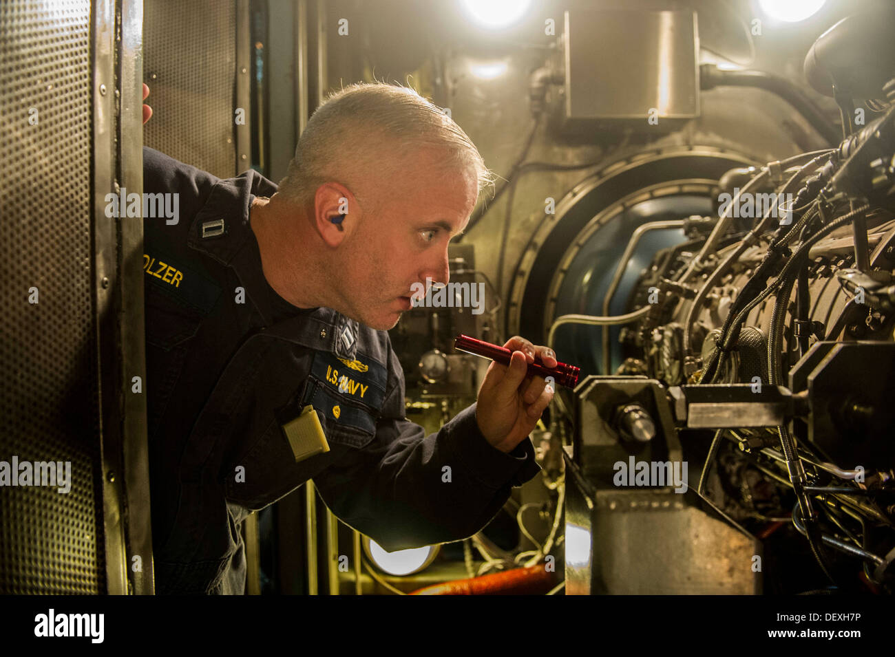 chief engineer, examines a gas turbine engine aboard the guided-missile destroyer USS Barry (DDG 52). Barry, homeported in Norf Stock Photo