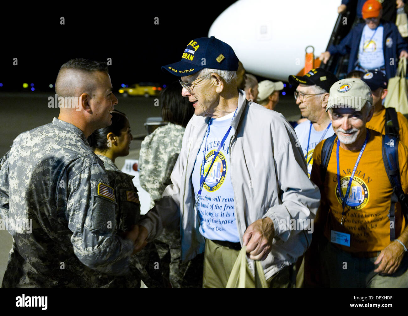 A U.S. Army Soldier shakes hands with a Korean War veteran Sept. 16, 2013, at the Denver International Airport. The 124 veterans were returning from a trip to Washington where they saw the monuments constructed in their honor. Honor Flight Northern Colora Stock Photo