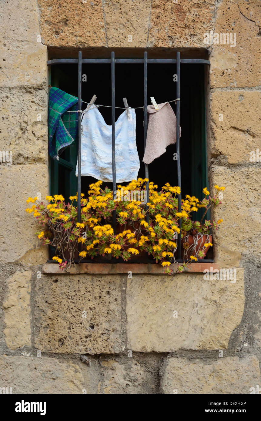 Drying washcloths and flowers in a window in the village of Sorano