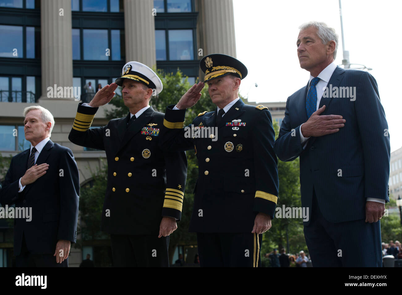 Secretary of Defense Chuck Hagel and Chairman of the Joint Chiefs of Staff Gen. Martin Dempsey stand with Chief of Naval Operations Adm. Jonathan Greenert and Secretary of the Navy Ray Mabus as taps is played during a wreath laying ceremony at the Navy Me Stock Photo