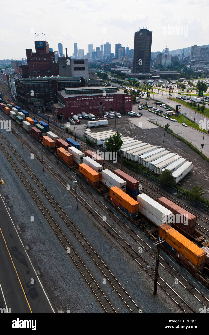 Container freight trains in the port of Montreal, city skyline in the background. Montreal, Quebec, Canada. Stock Photo