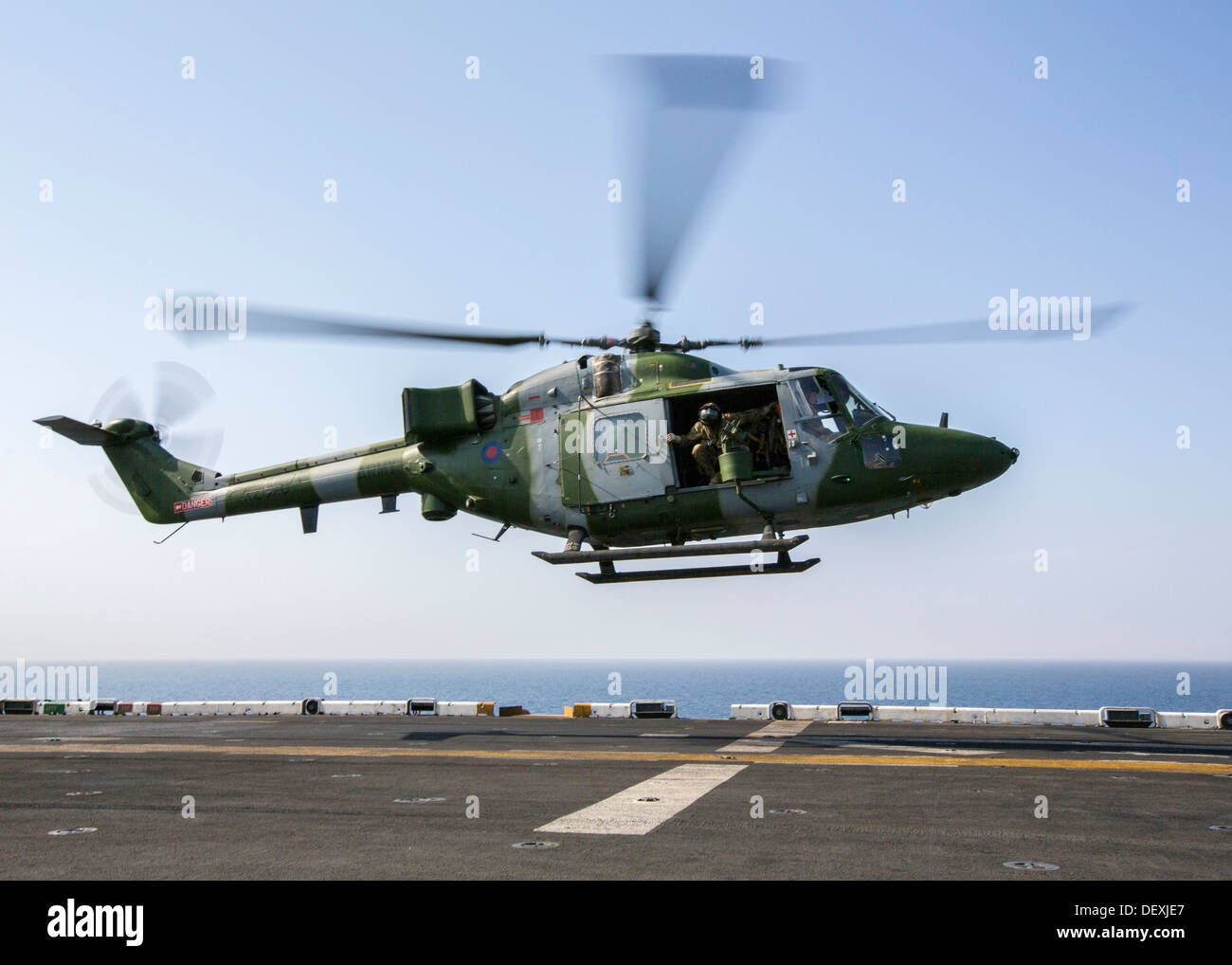 A Westland Lynx battlefield helicopter assigned to United Kingdom’s Army Air Corps lands on the flight deck of the USS Kearsarge (LHD 3) while conducting landing qualifications, at sea, Sept. 15, 2013. The 26th MEU is a Marine Air-Ground Task Force forwar Stock Photo