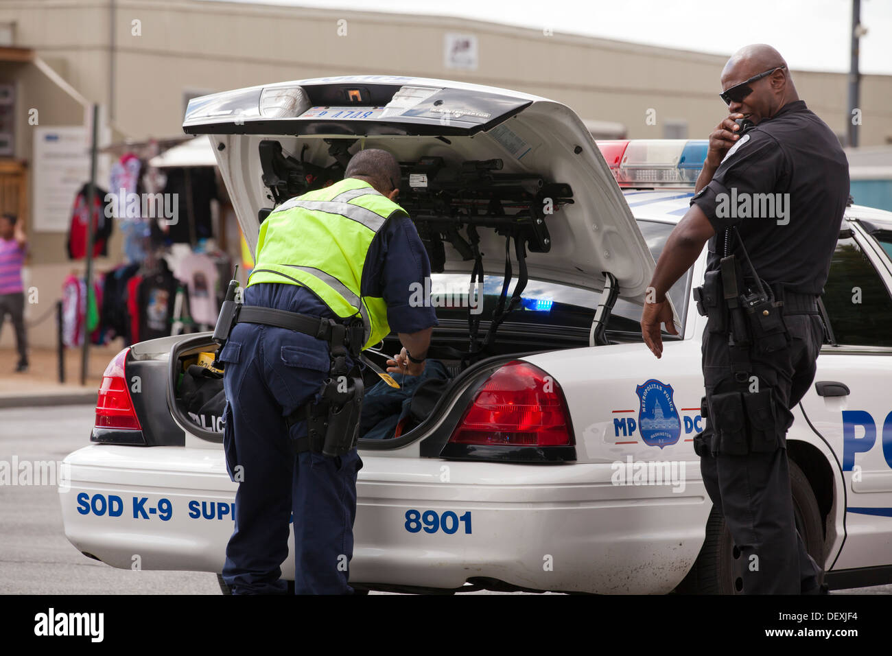Washington DC Metropolitan police officer looking in trunk of cruiser