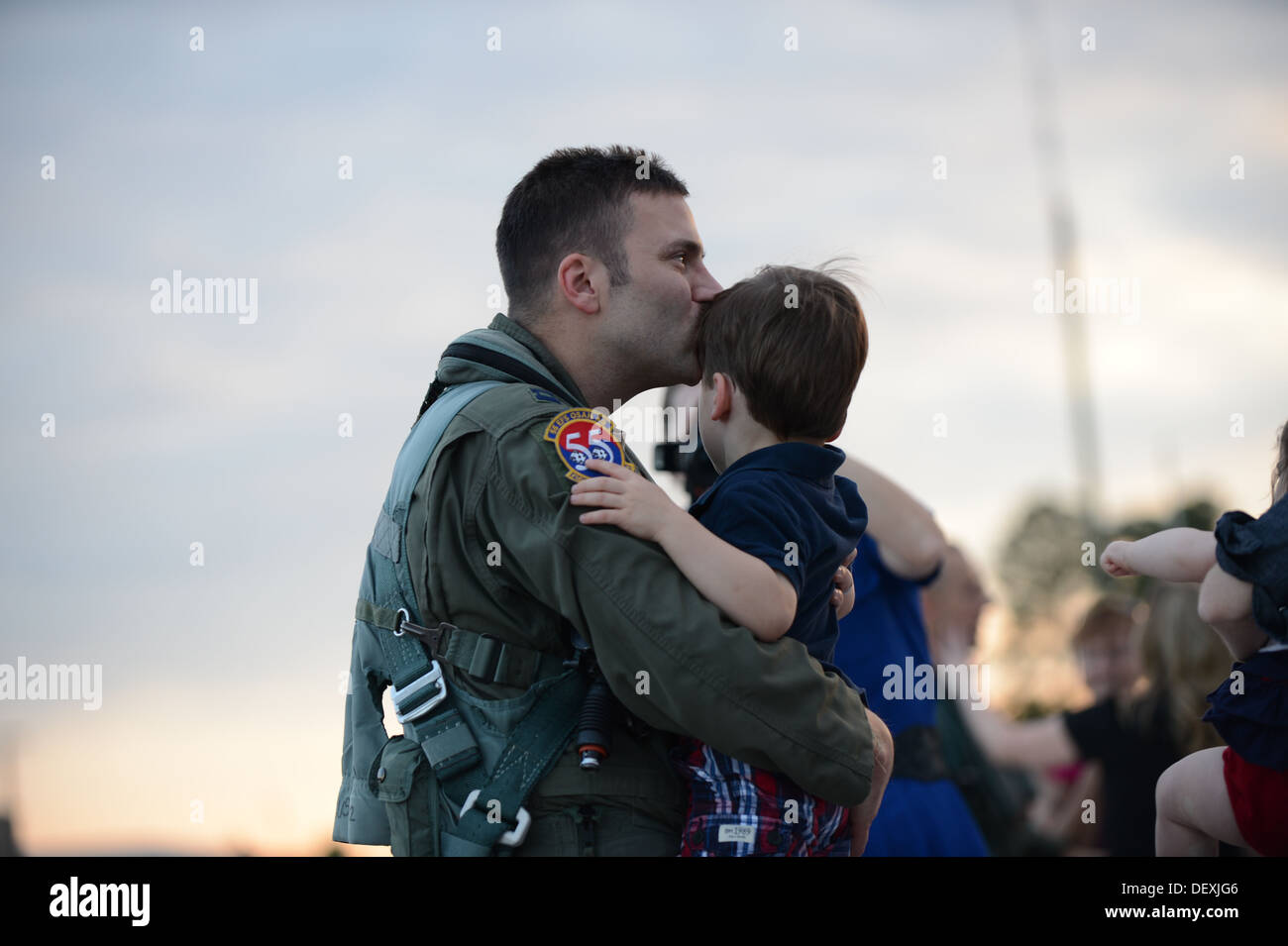 SHAW AIR FORCE BASE, S.C. – U.S. Air Force Capt. Robbie Sandwith, a F-16 pilot assigned to the 55th Fighter Squadron, Shaw Air Force Base kisses his son on the forehead upon returning home after a six-month deployment to Osan Air Base, Republic of Korea. Stock Photo