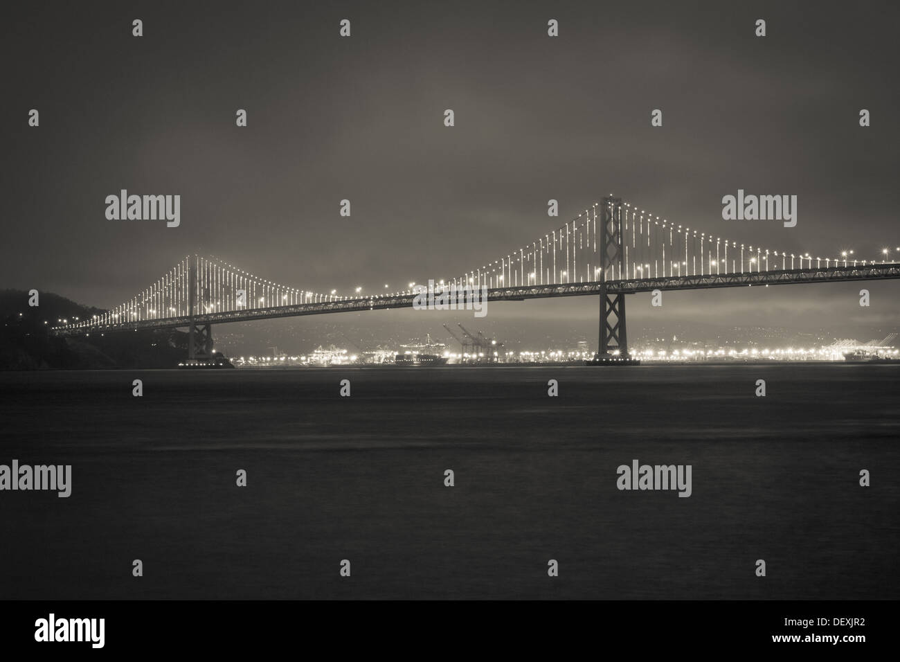 A blackandwhite view of "The Bay Lights" light sculpture by Leo Villareal on the Bay Bridge in