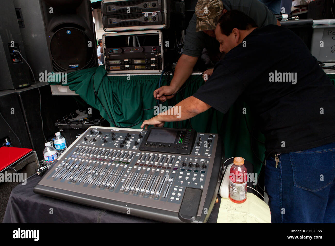 Audio technicians preparing mixer console - USA Stock Photo