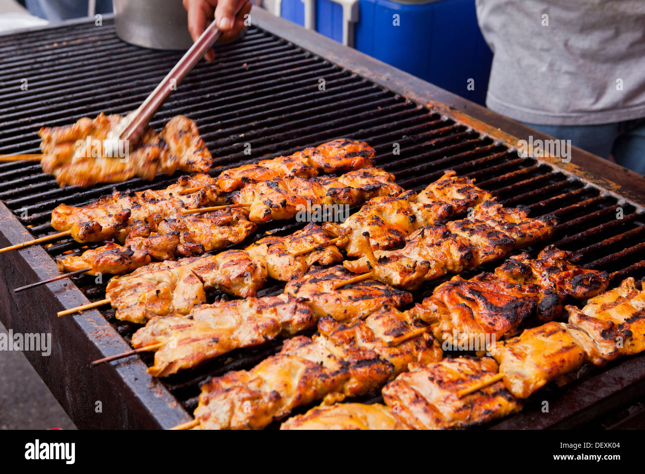 Closeup of chicken skewers cooking on barbecue grill USA Stock Photo