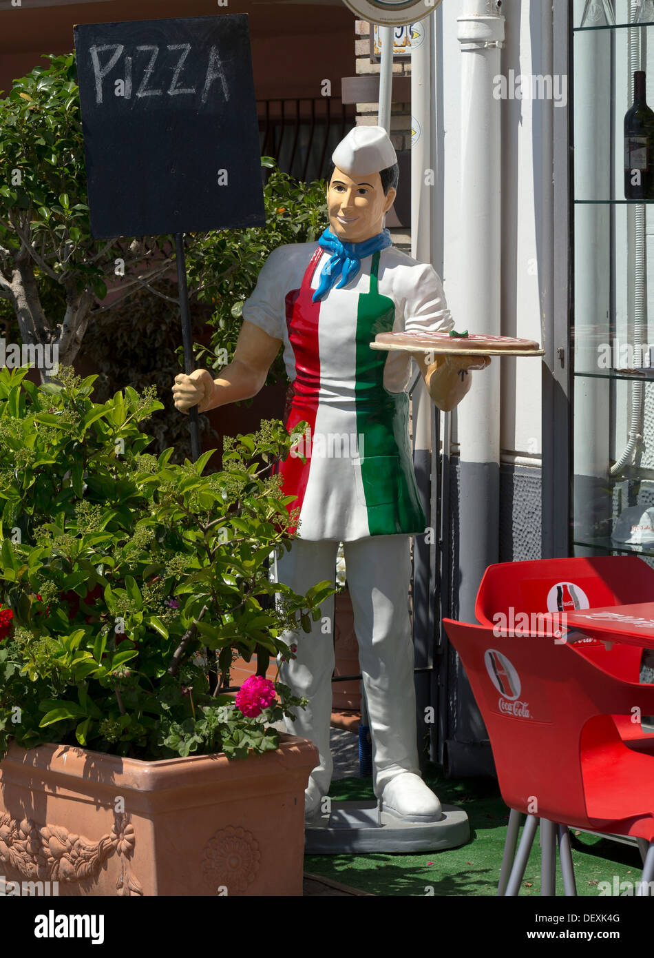 Painted statue or mannequin of a waiter dressed in Italian colours at a restaurant in Taormina Stock Photo