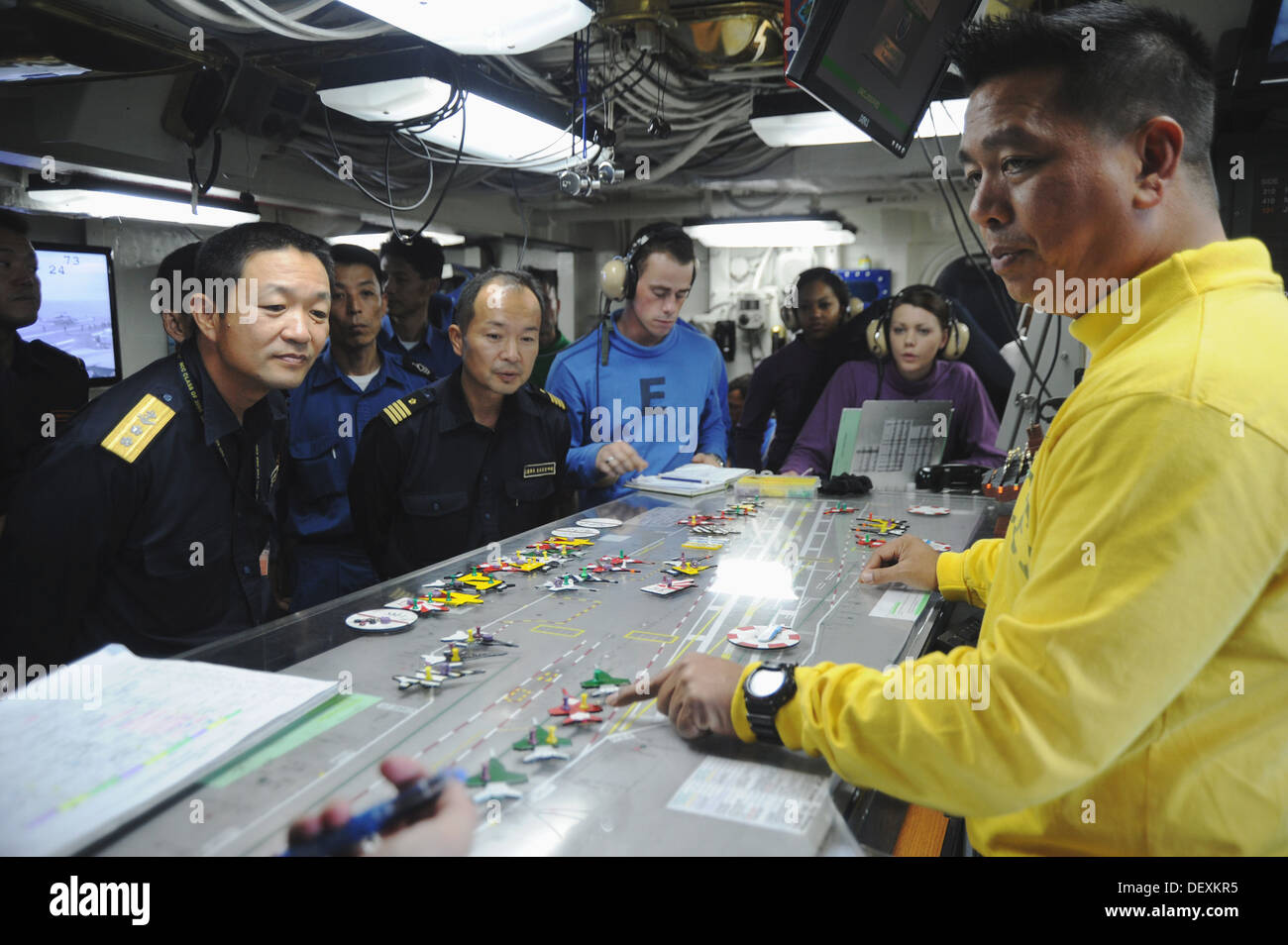 Lt. Cmdr. Ivan Borja, right, a flight deck handler aboard the aircraft ...