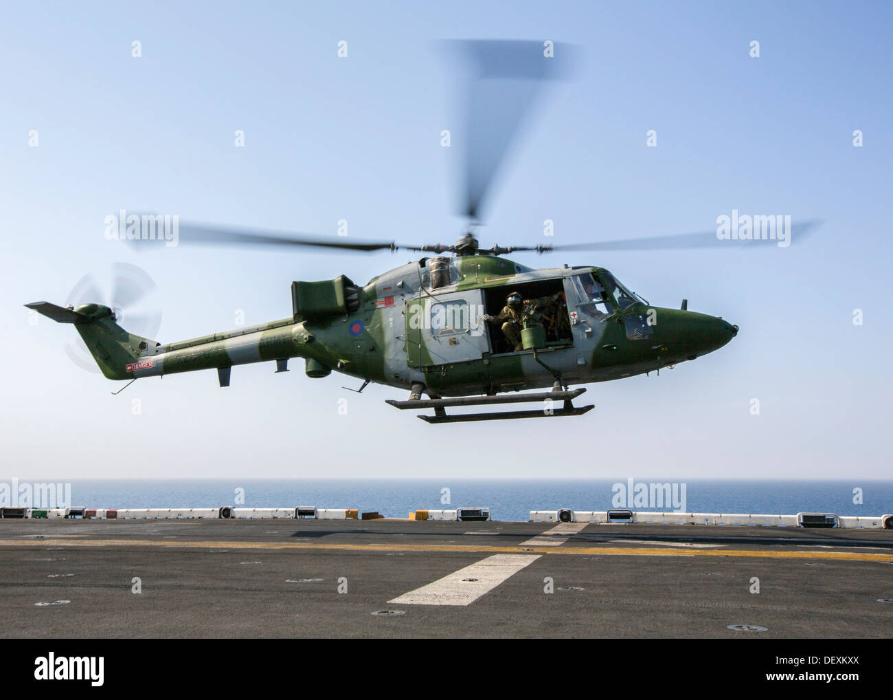 United Kingdom Army Air Corps Westland Lynx battlefield helicopter lands on the flight deck of the amphibious assault ship USS Kearsarge (LHD 3). Kearsarge is the flagship for the Kearsarge Amphibious Ready Group and, with the embarked 26th Marine Expedit Stock Photo