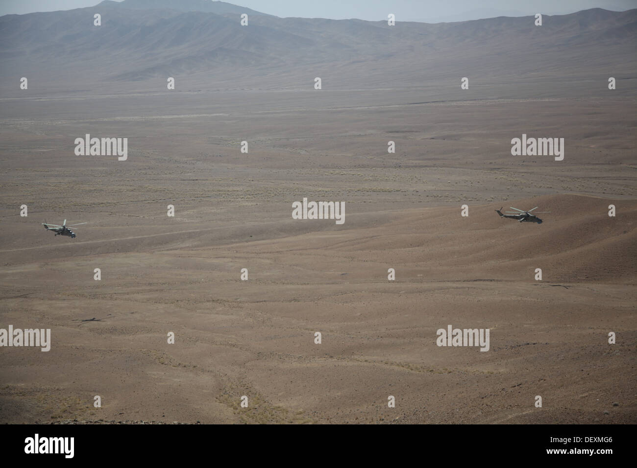Afghan Air Force Mi-35 Hind helicopters conduct a live fire exercise to help develop the Afghan Tactical Air Coordinators in Logar Province, Afghanistan, Sept. 18, 2013. The ATAC program will help the Afghan National Army soldiers on the ground integrate Stock Photo