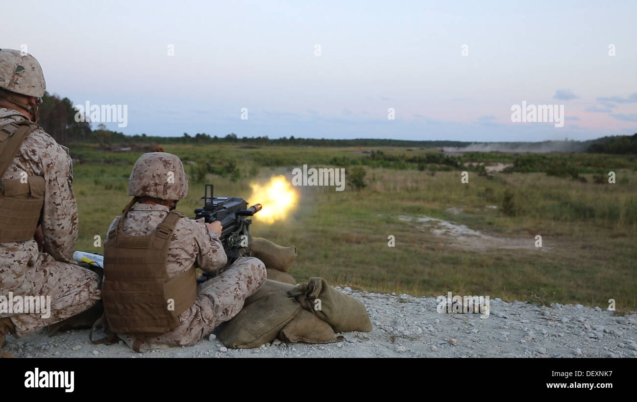 A Marine with Bridge Company, 8th Engineer Support Battalion, 2nd Marine Logistics Group fires an automatic Mk. 19 Grenade Launcher at targets approximately 1,000 yards away during a grenade training exercise aboard Camp Lejeune, N.C., Sept. 17, 2013. The Stock Photo