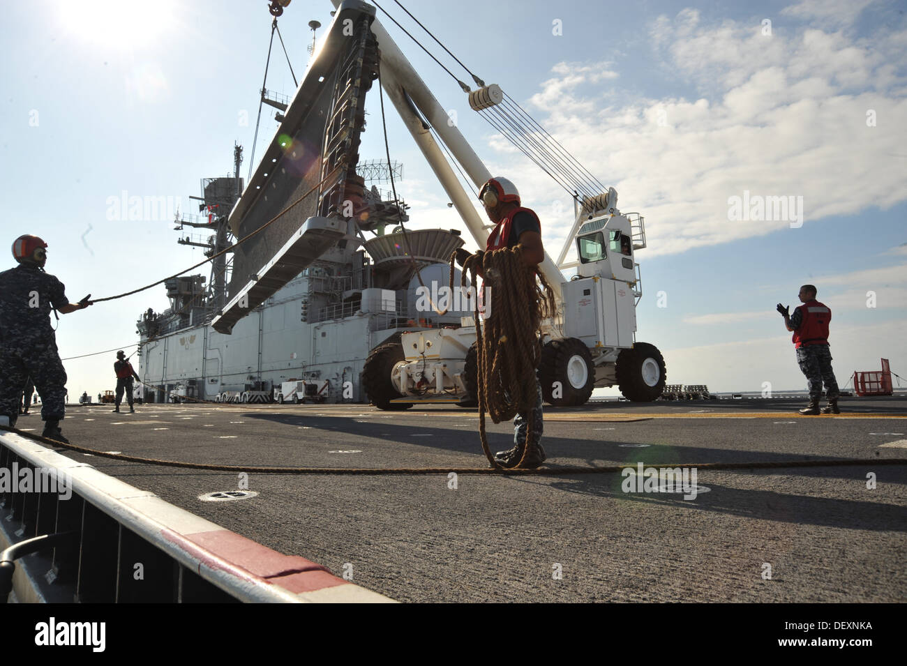 Sailors from crash and salvage move the 'ships brow from the flight