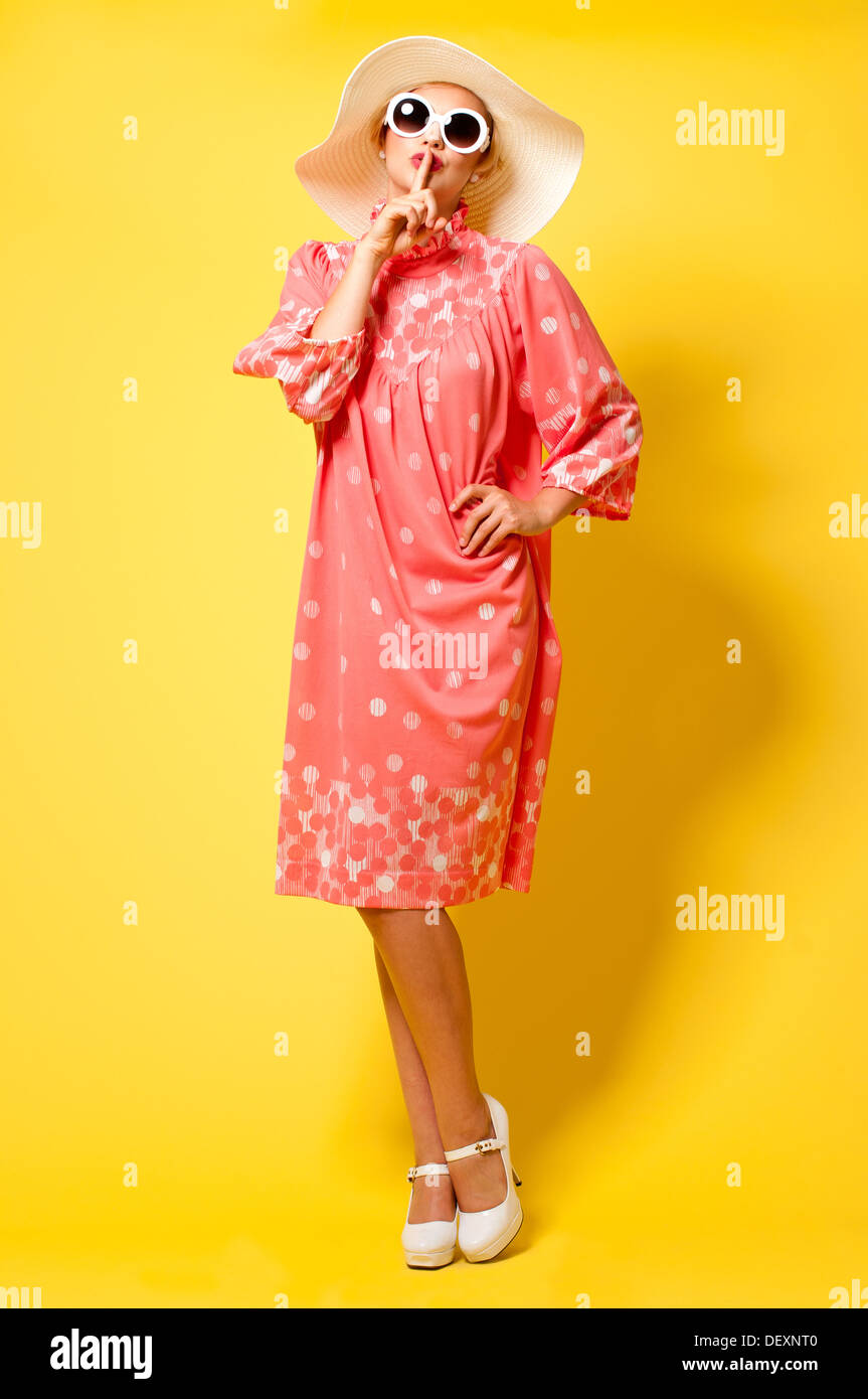 studio vintage fashion full length portrait of a female model wearing 60s vintage dress Stock Photo