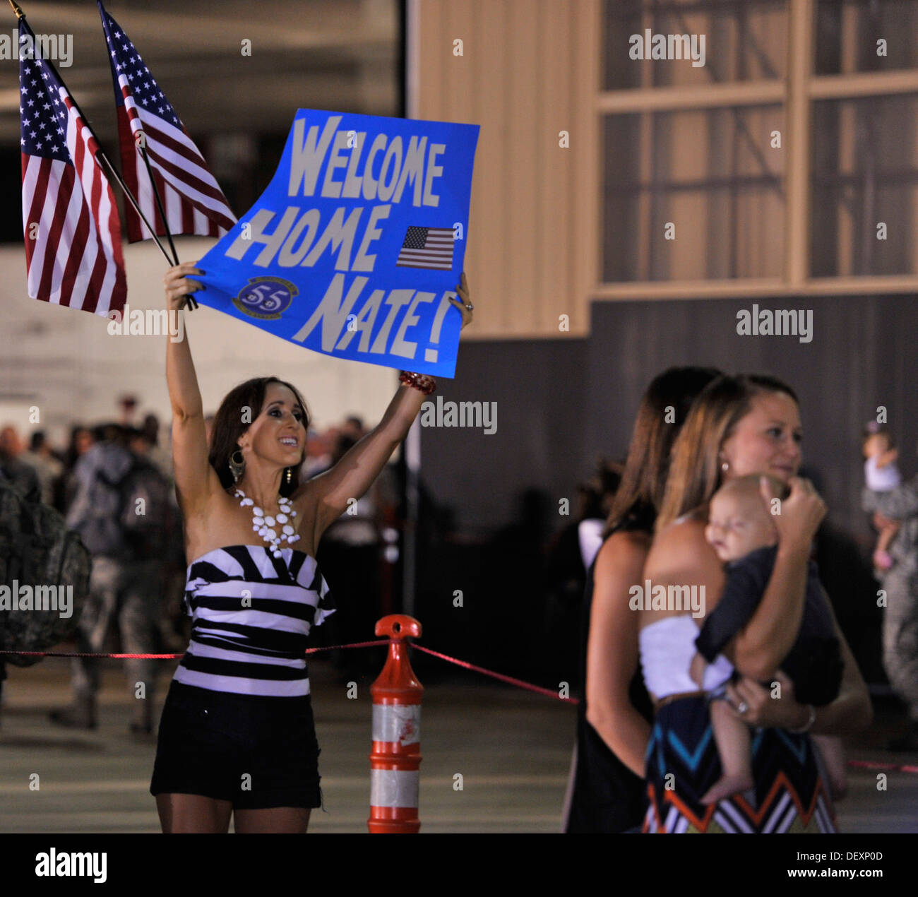 A family member waits for the return of her Airman, Shaw Air Force Base, S.C., Sept. 19, 2013. Airmen from the 20th Fighter Wing were deployed to Osan, Air Base, Republic of Korea, for five months in an effort to bolster regional security in the region. Stock Photo