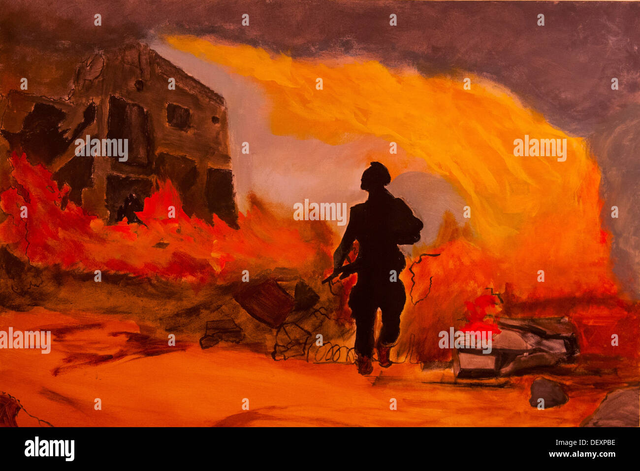SAN DIEGO, Calif. -- A war fighter is silhouetted in fire in one of the paintings featured in the Combat Arts exhibit in the Southwestern University art gallery, Sept. 14, 2013. The paintings in the exhibit were all created by Iraq and Afghanistan war vet Stock Photo