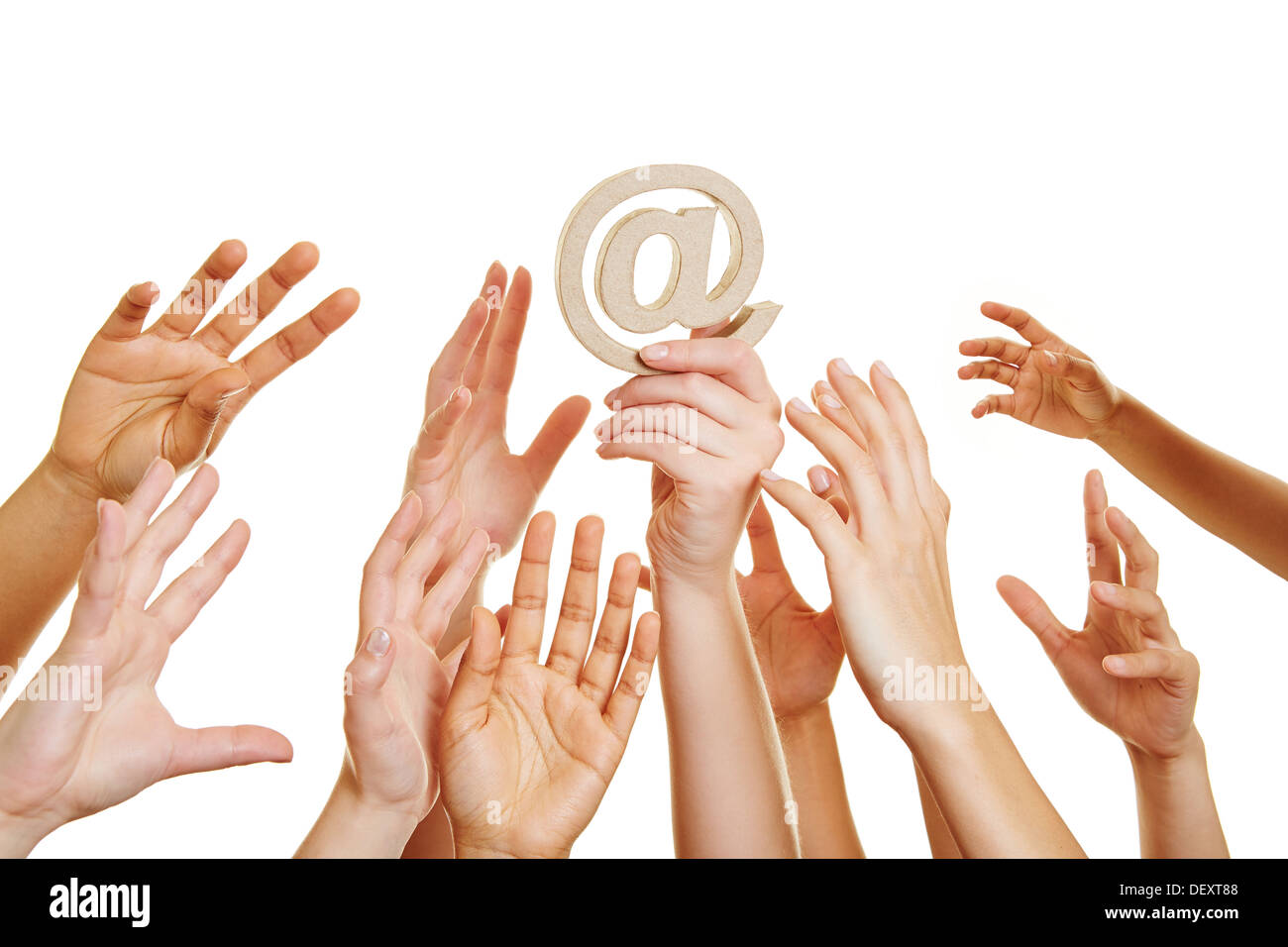 Many desperate hands reaching for at sign as internet symbol Stock Photo