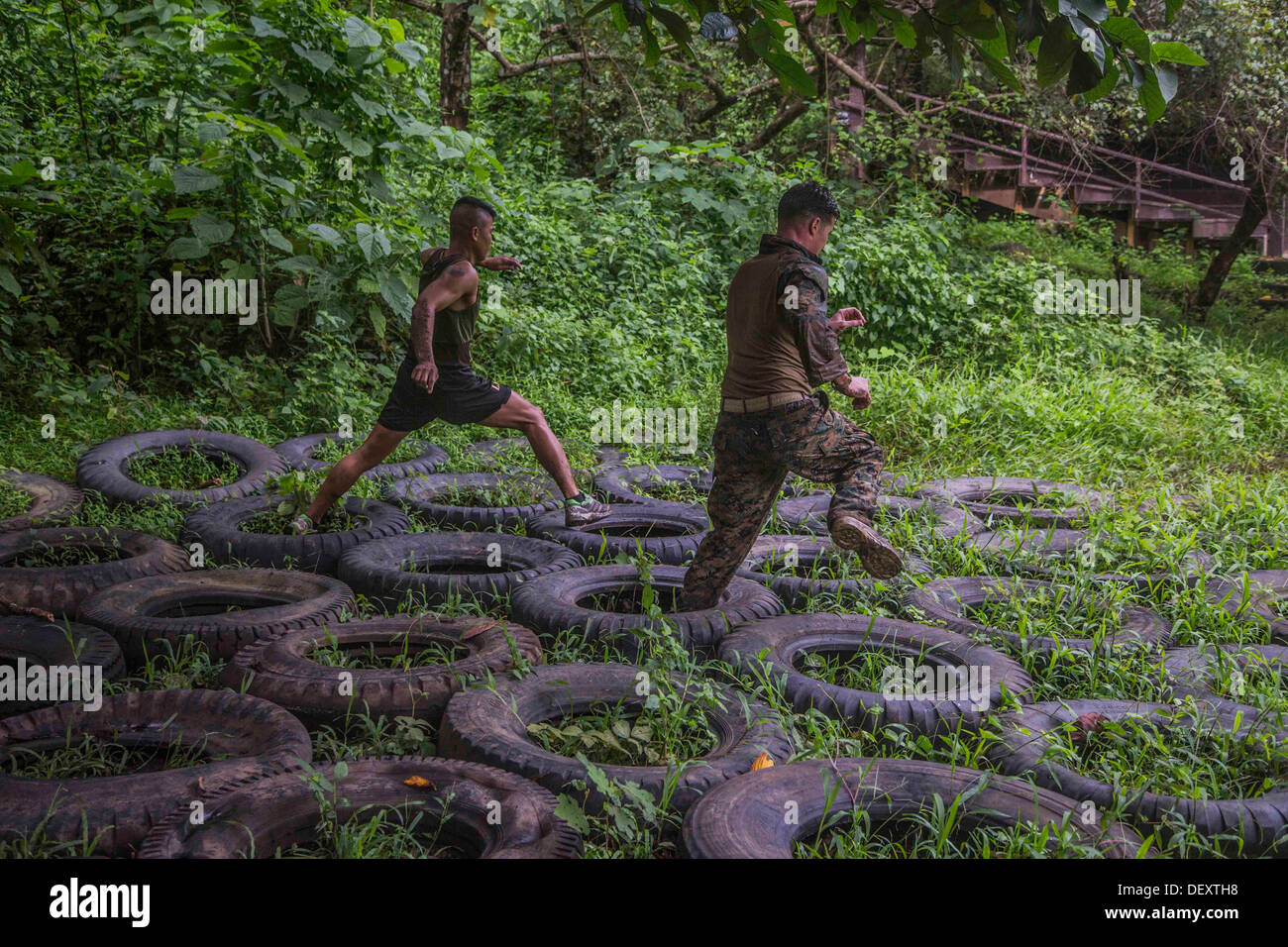 U.S. and Philippine Marines run through a jungle obstacle course during Amphibious Landing Exercise 2014 (PHIBLEX 14) at Marine Stock Photo