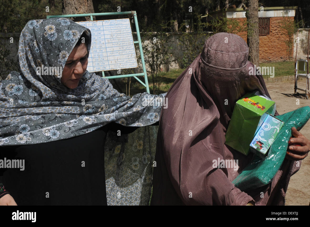 Sadiqa Jalali, directorate of women affairs, passes out humanitarian aide items after a women's shura in Tarnek Wa Jaldek District Sept. 18, 2013. Stock Photo