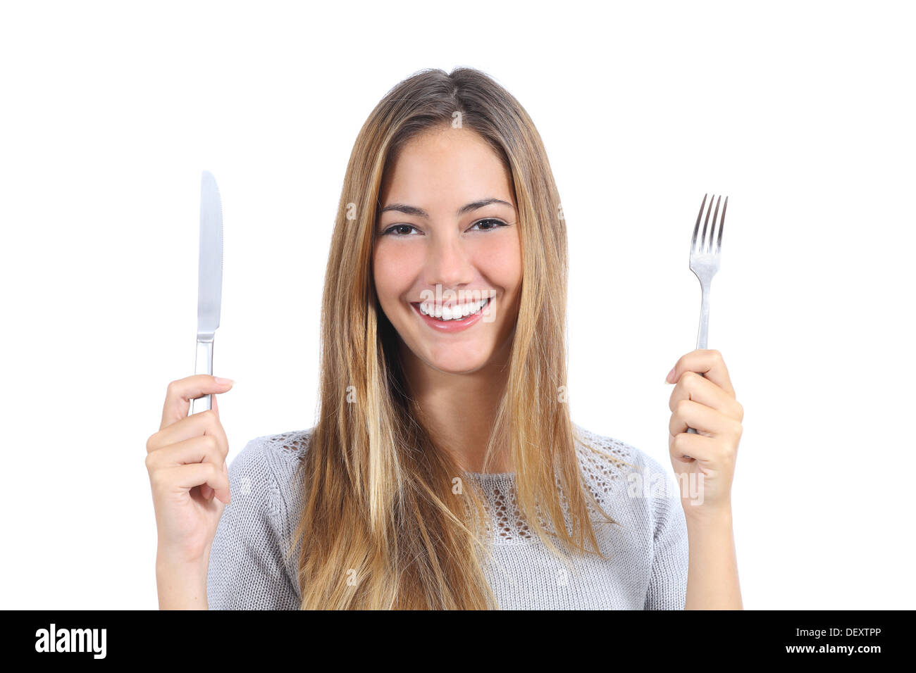 Beautiful woman holding a fork and a table knife isolated on a white background Stock Photo