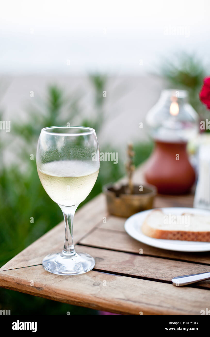 Glass of white wine on a celebratory table. Stock Photo