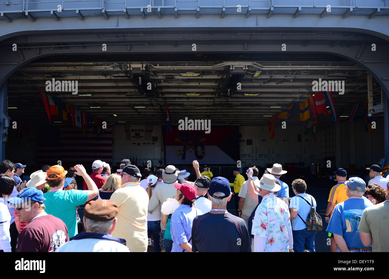 Guests ride an aircraft elevator to the hangar bay aboard the aircraft carrier USS Ronald Reagan (CVN 76) during a tour. Ronald Stock Photo