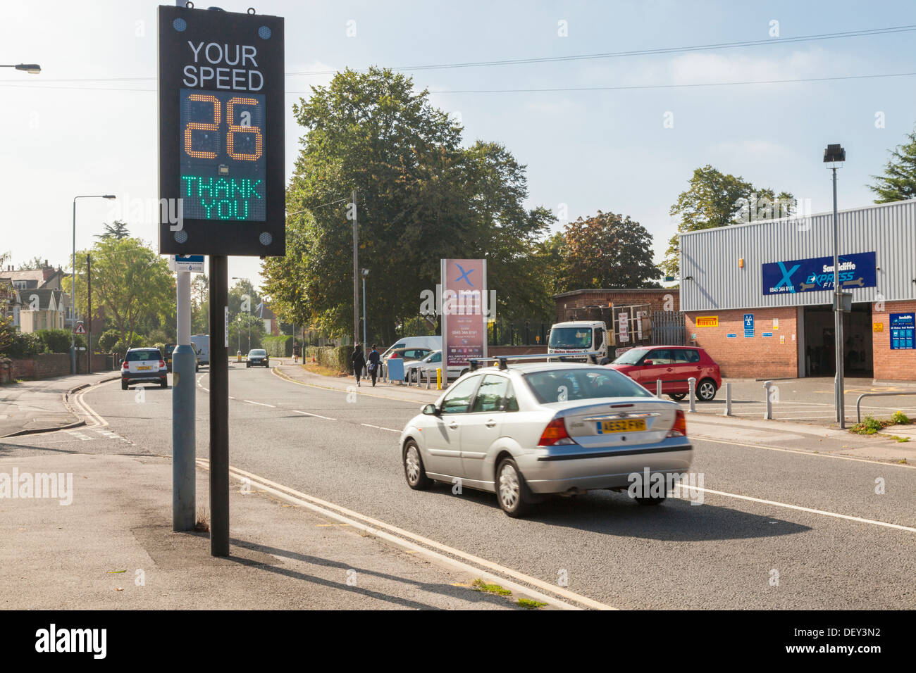 Electronic sign showing vehicle speed. Car within the speed limit as it passes a traffic speed warning indicator, Nottinghamshire, England, UK Stock Photo