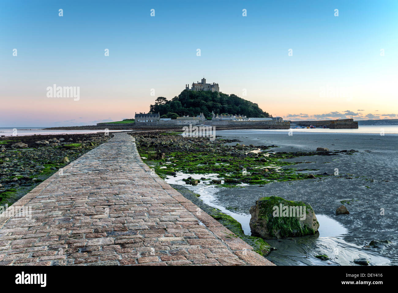 The sea causeway at low tide leading to St Michael's Mount a small isle off Marazion near Penzance in Cornwall Stock Photo