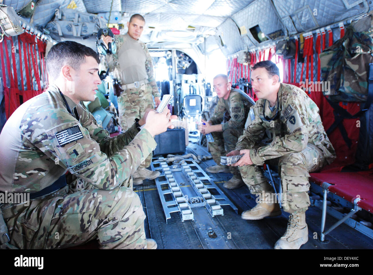 First Lt. Jared Thompson (foreground), a CH-47 Chinook helicopter pilot from B Company, 2nd Battalion (General Support), 149th Aviation Regiment (Texas/Oklahoma National Guard), serving under the 10th Combat Aviation Brigade, provides a mission brief to S Stock Photo