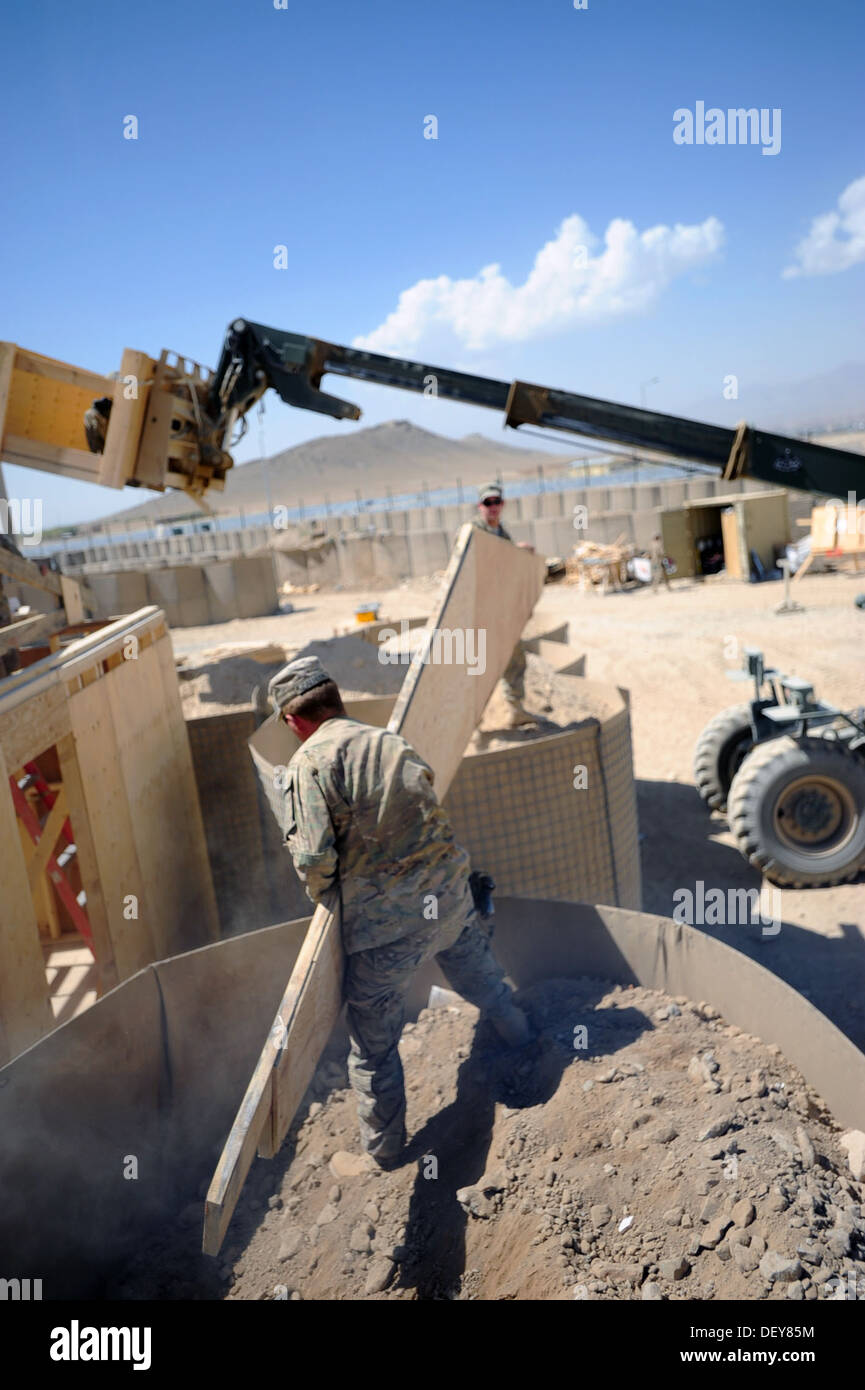 U.S. Army soldiers with the 149th Vertical Construction Company, Kentucky National Guard, lift a truss so they can move it in to place during the construction of a building that will be used as living quarters for soldiers on Forward Operating Base Lightn Stock Photo