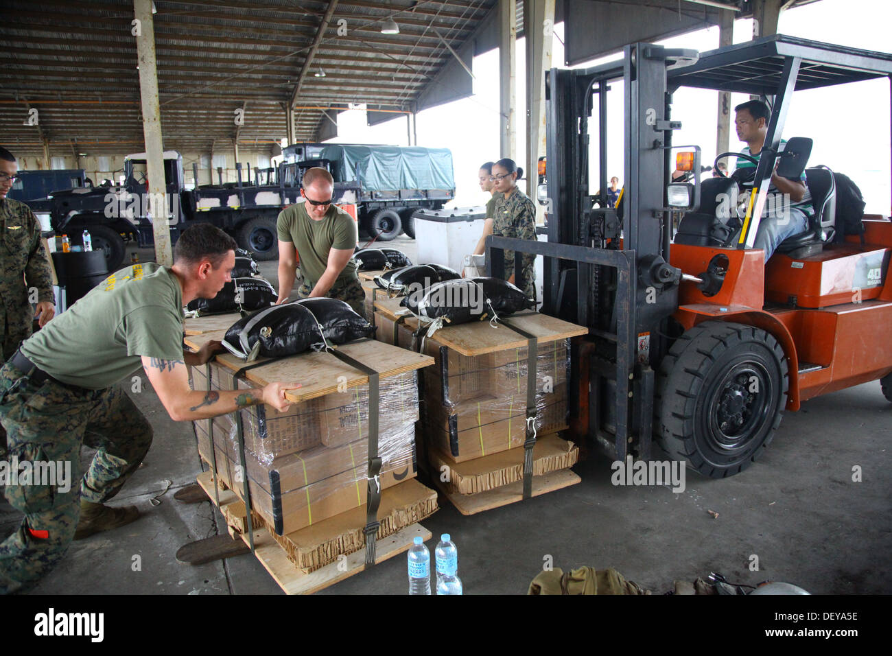 Marines prepare pallets of meals-ready-to-eat to be loaded into an MV-22B Osprey at Clark Air Field for a supply drop mission ov Stock Photo