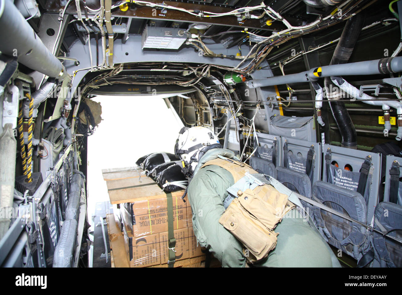 Staff Sgt. Travis Borkowski pushes a pallet of meals-ready-to eat strapped to parachutes out of an MV-22B Osprey over Crow Valley, Capas, Tarlac, Republic of the Philippines, Sept. 19 during Amphibious Landing Exercise 2014. Bilateral Philippine-U.S. Mari Stock Photo