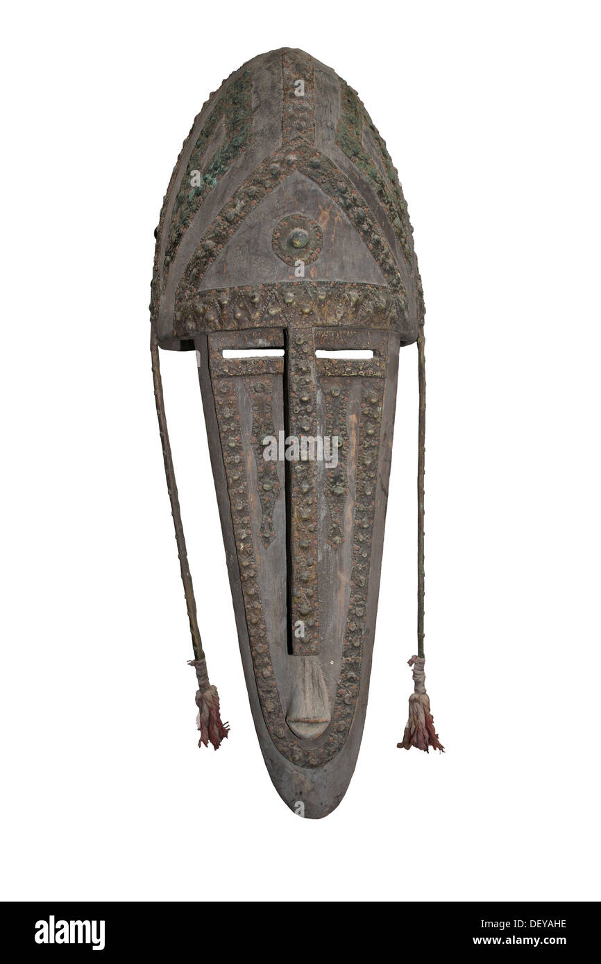Wood mask with inlaid brass typically elongated face with a pointed jaw of the Bamana/Bambara people, Mali Stock Photo