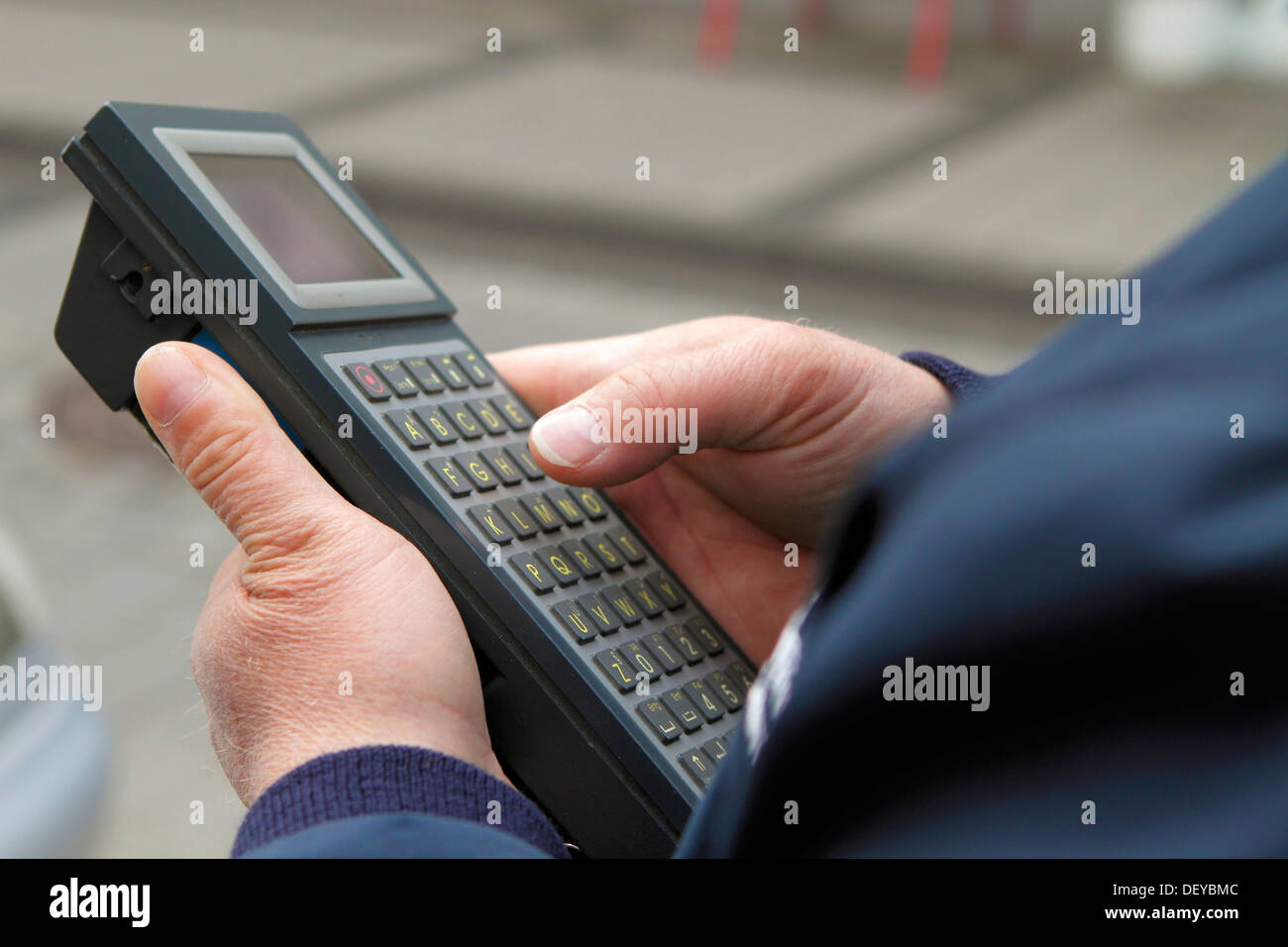 Employee of the regulatory authority entering data into a electronic input device, Bergisches Land region Stock Photo