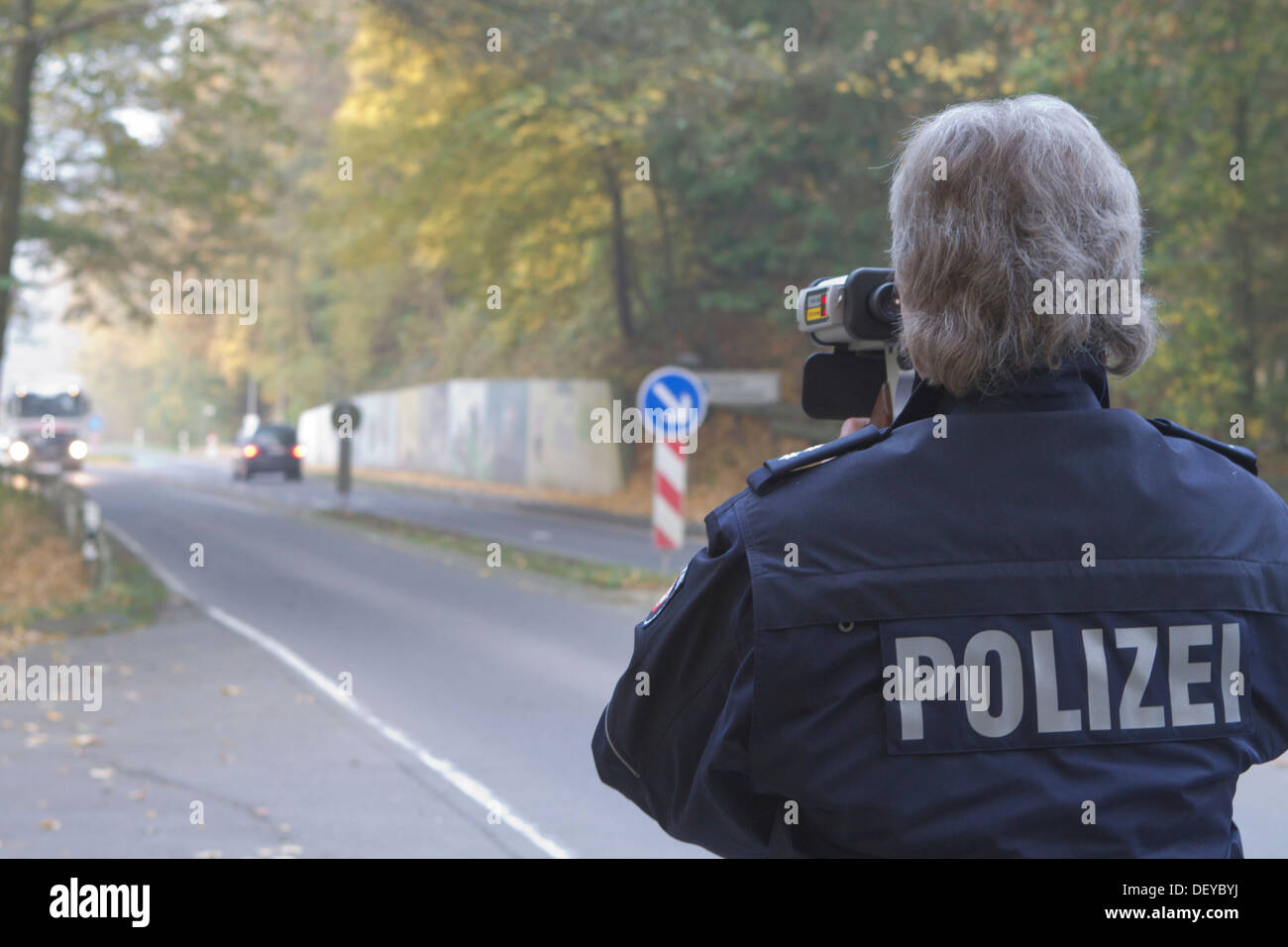 Policeman operating a radar gun, speed control, on 24/10/2012, Oberbergischer Kreis district, Lindlar, North Rhine-Westphalia Stock Photo