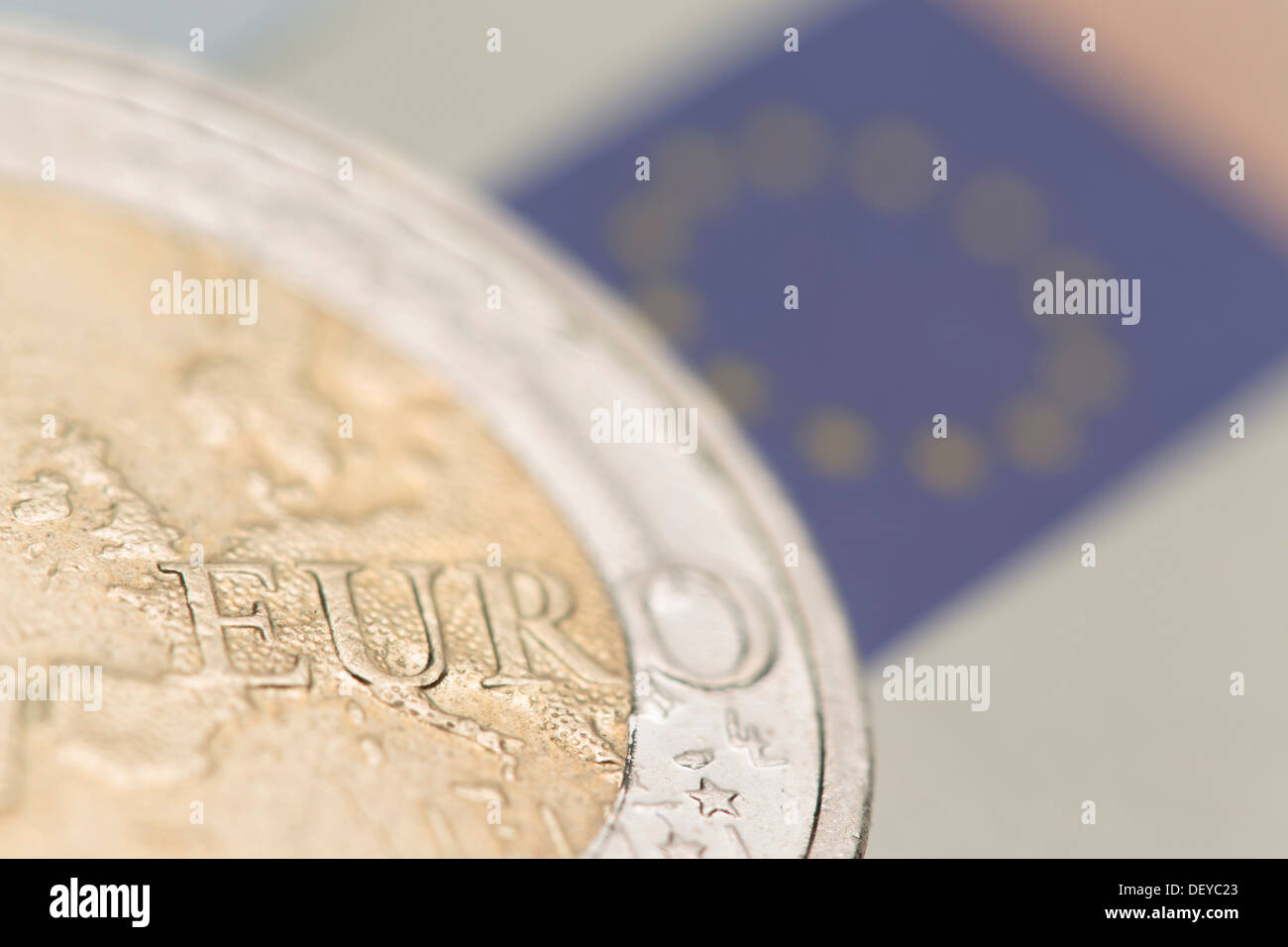 Euro crisis, a 2-euro coin and the European flag on a 50 euro banknote at back Stock Photo