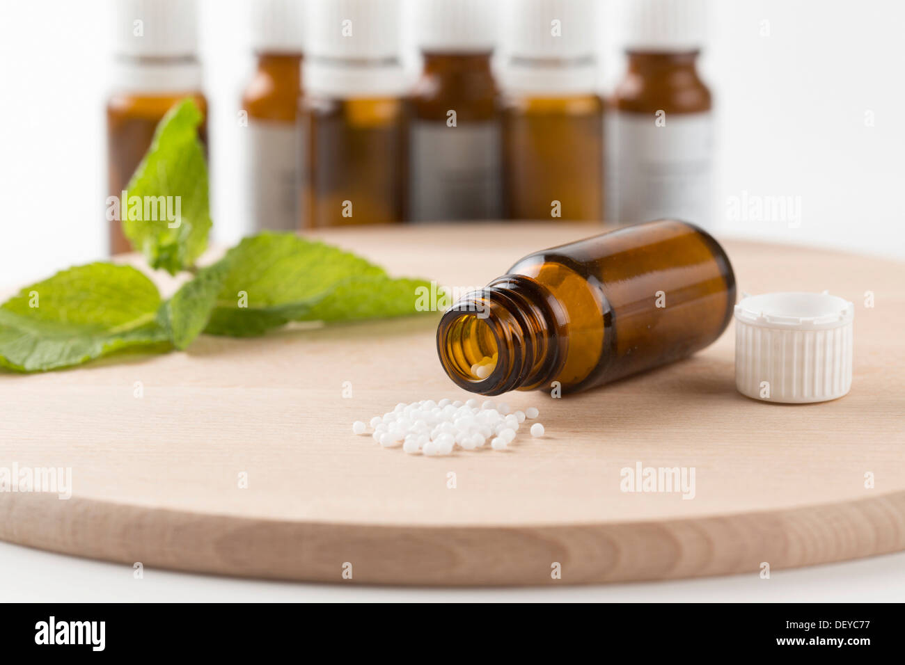 Open bottle with globules on a wooden board, homoeopathy, Lindlar, Bergisches Land, Germany Stock Photo