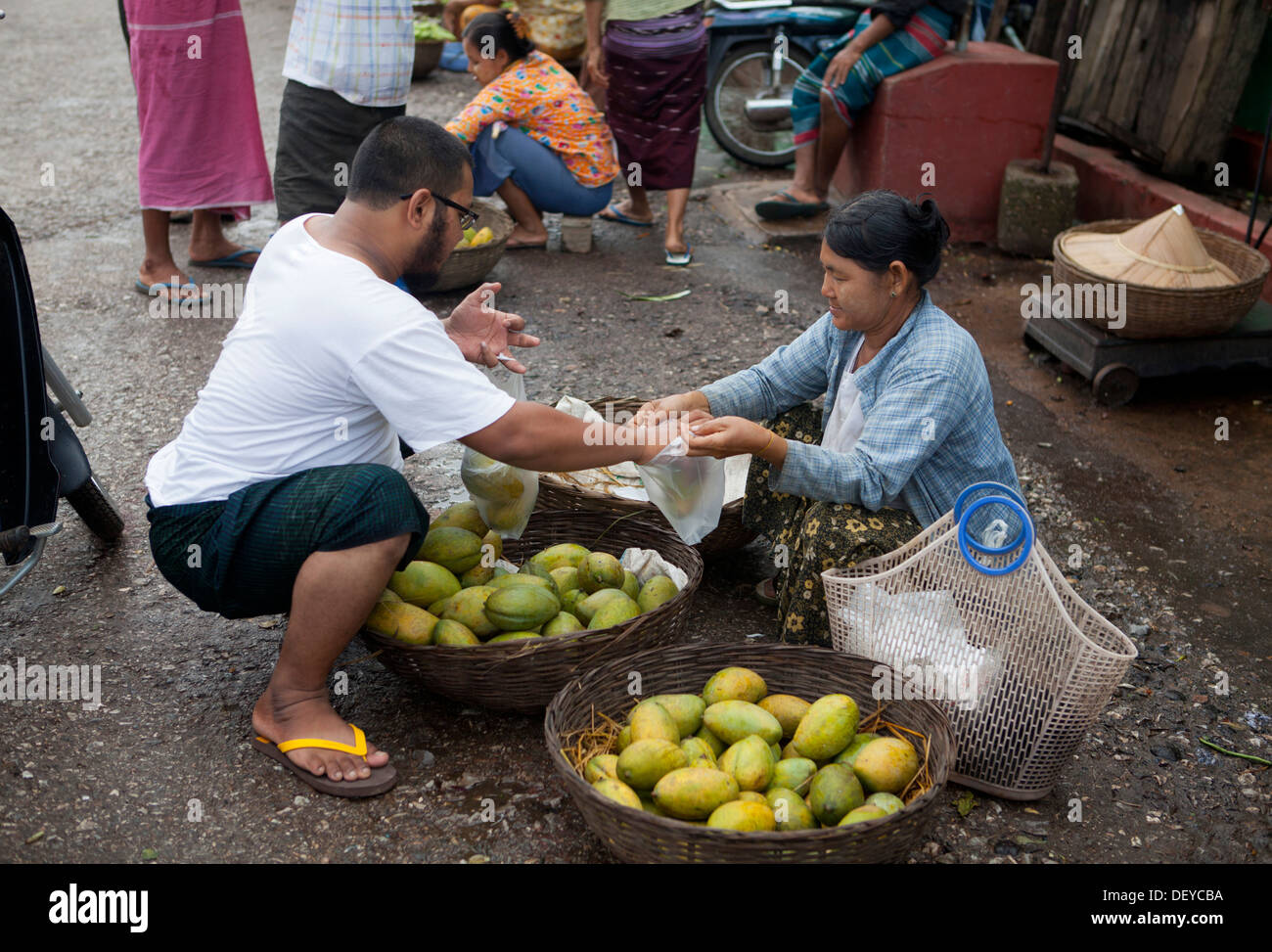 Woman sells fruit on the street in a hpa an hires stock photography