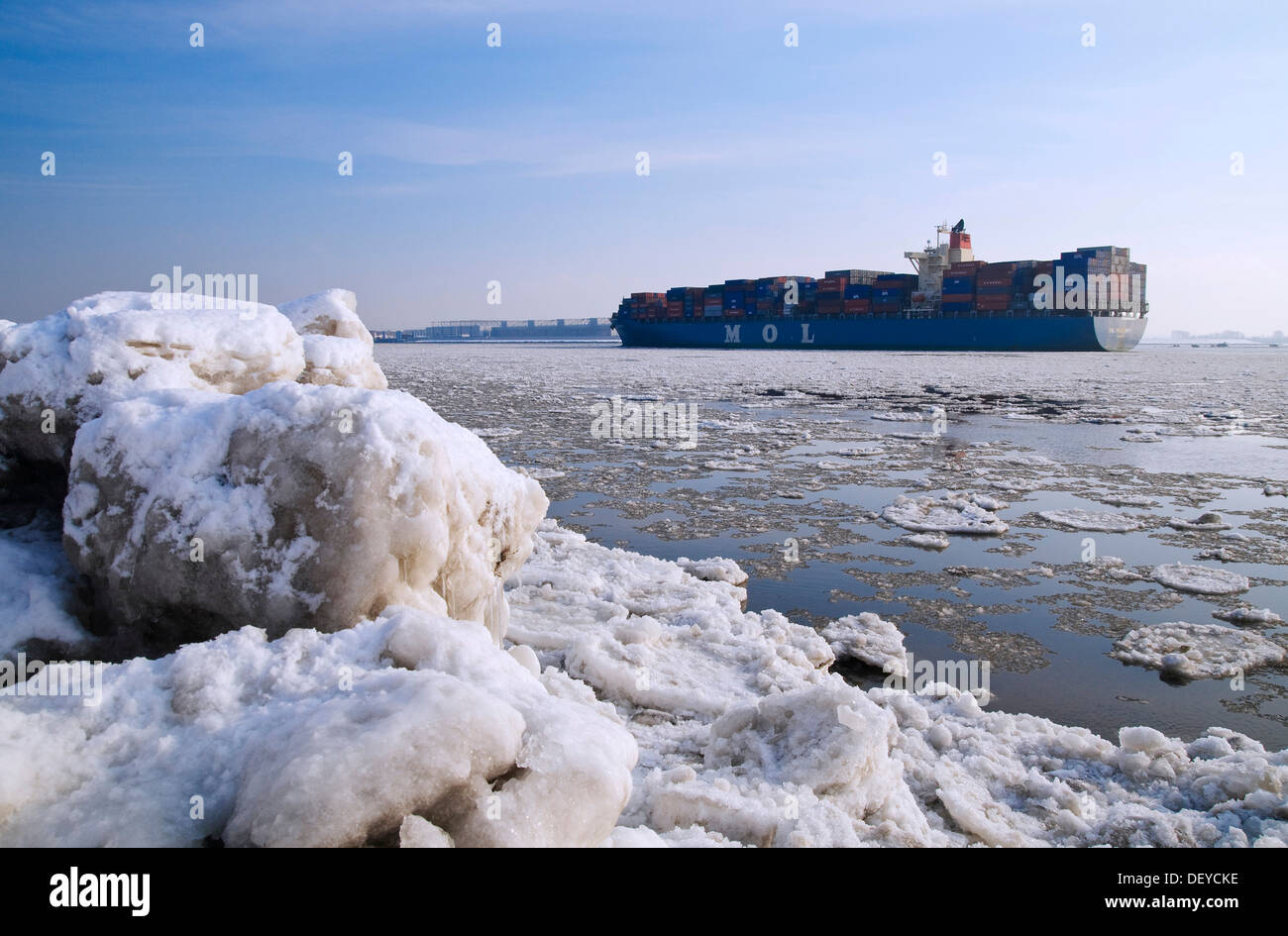 A container ship travelling on the wintery Elbe river at Blankenese, Hamburg Stock Photo