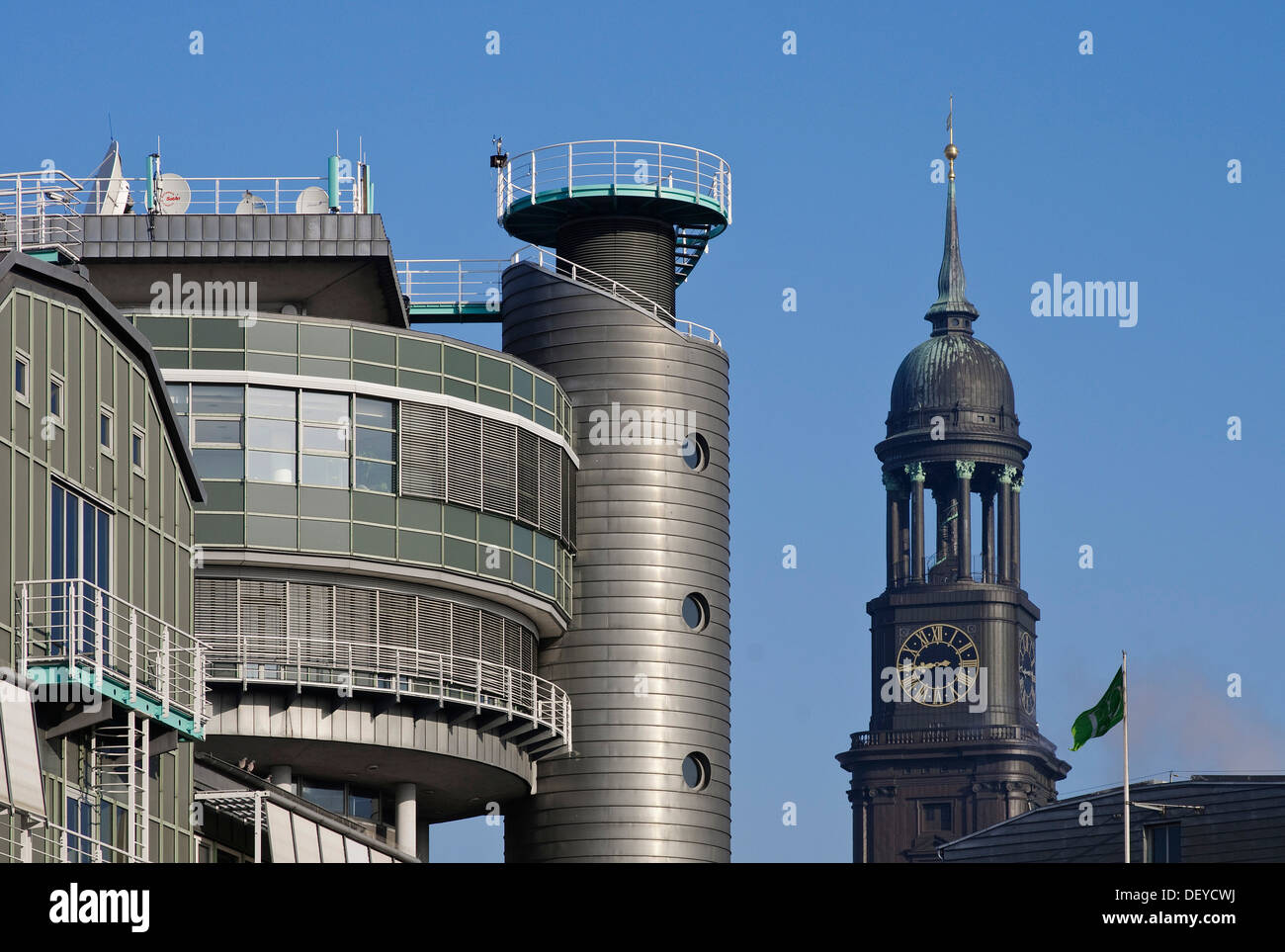 Ancient and new buildings, the tower of the 'Hamburger Michel', nickname for the St. Michaelis Cathedral, behind the building of Stock Photo