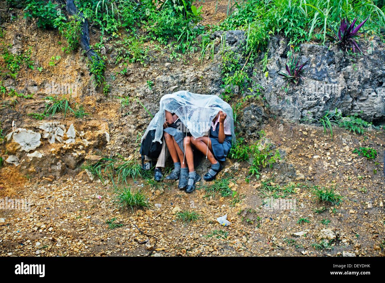 Children sheltering from the rain, Montego Bay, Jamaica, West Indies