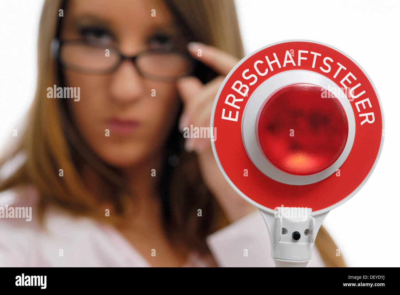 Woman holding a red police signalling disk, Erbschaftssteuer, inheritance tax written on it Stock Photo