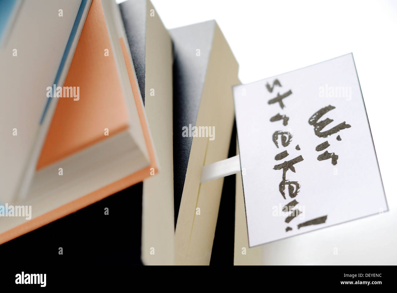 Stack of books with a strike sign as a bookmark, symbolic image for students' strike, education problems Stock Photo