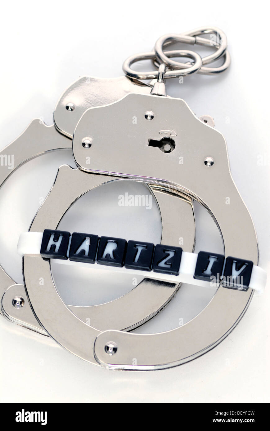 Handcuffs and Hartz IV-lettering, obligation to work for Hartz IV recipients Stock Photo