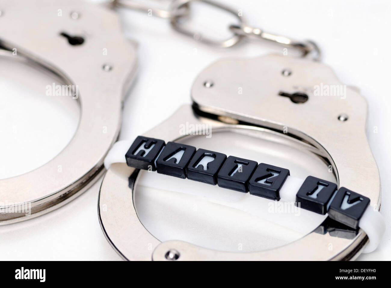 Handcuffs and Hartz IV-lettering, obligation to work for Hartz IV recipients Stock Photo