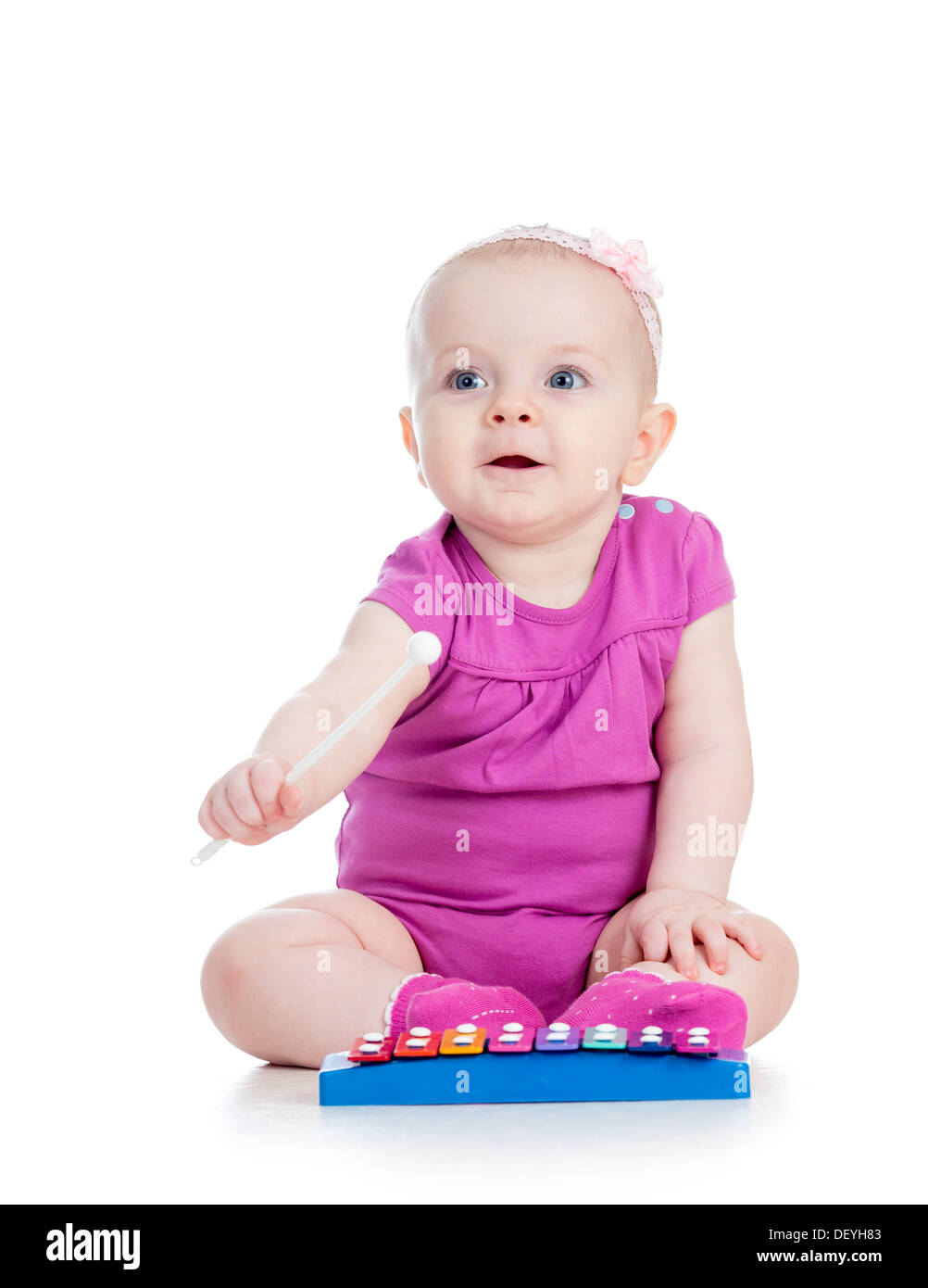 cute girl baby playing with musical toy Stock Photo