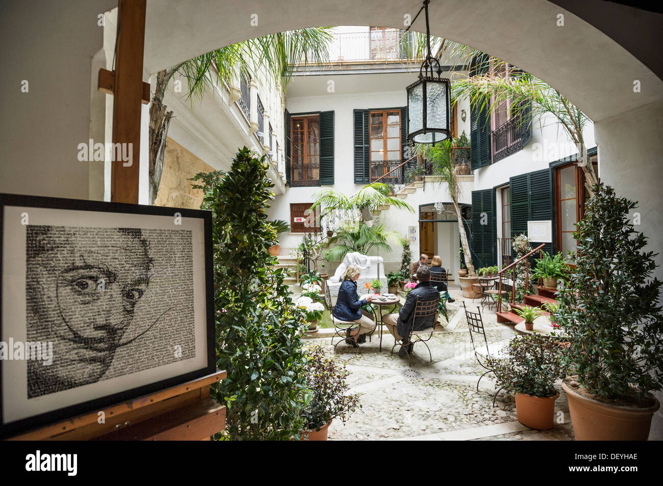 Courtyard with a café, portrait of Salvador Dali at front, Dali Museum, Palma de Mallorca, Majorca, Balearic Islands, Spain Stock Photo