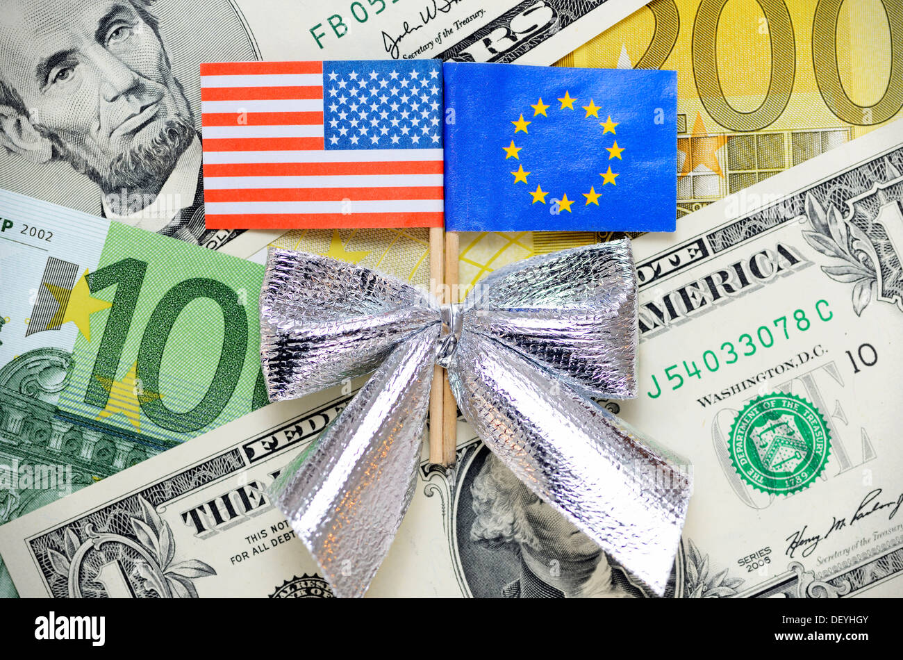 Flag of the USA and the EU with gift loop on dollar marks and euronotes, symbolic photo foreign trade zone between the USA and t Stock Photo