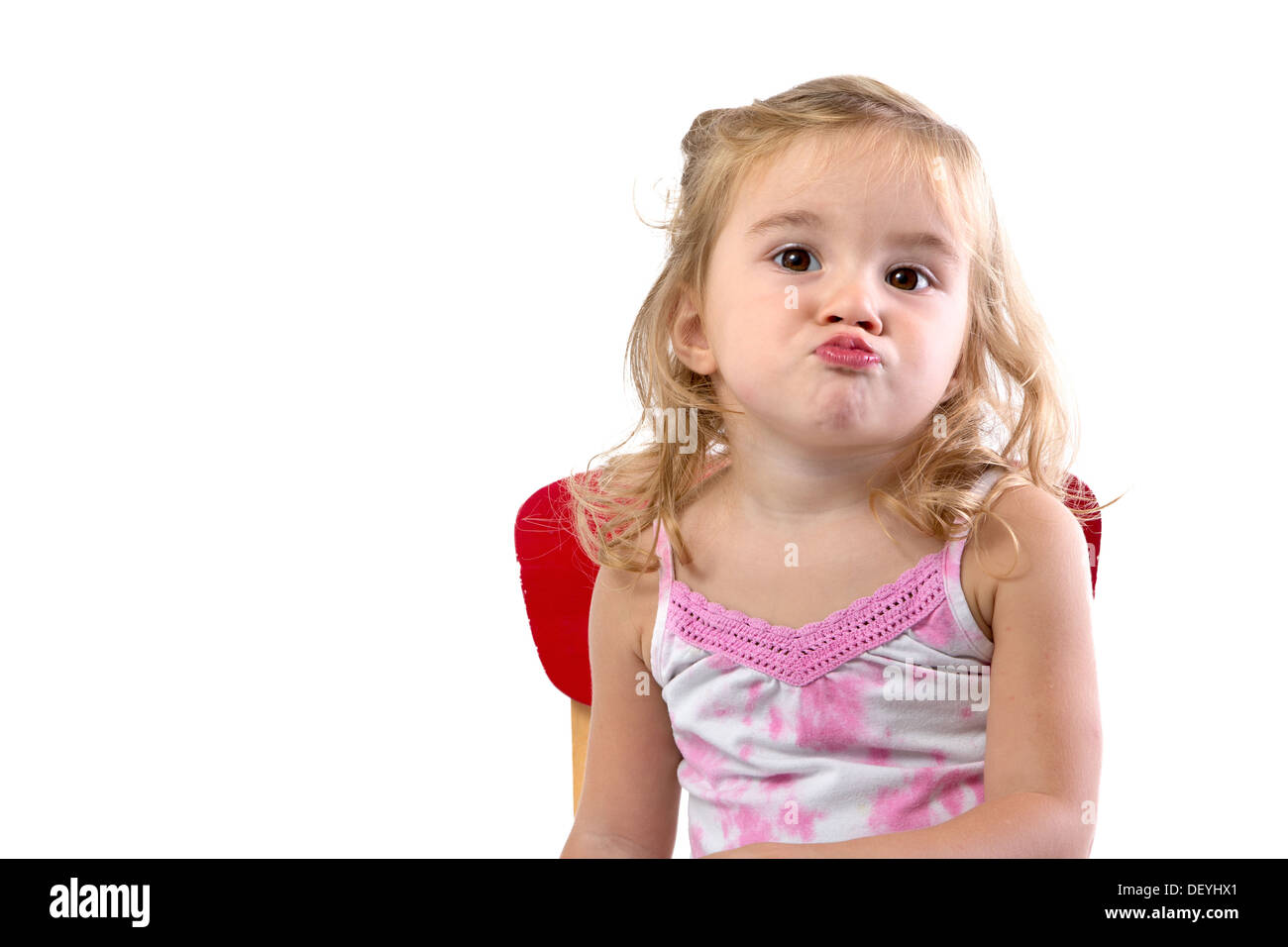 Toddler girl very bored her lips and shoulders are showing the the boredom Stock Photo